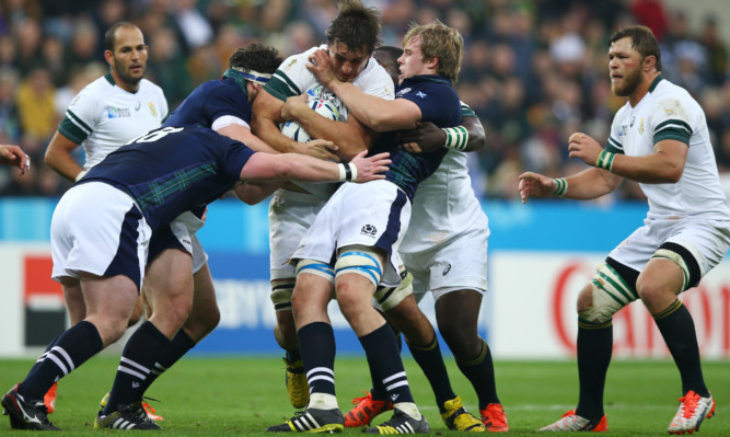 Three Scots hold up South Africa's Eden Etzebeth in the second half of Saturday's RWC game at Newcastle.