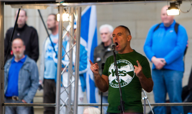 Tommy Sheridan speaking on stage.