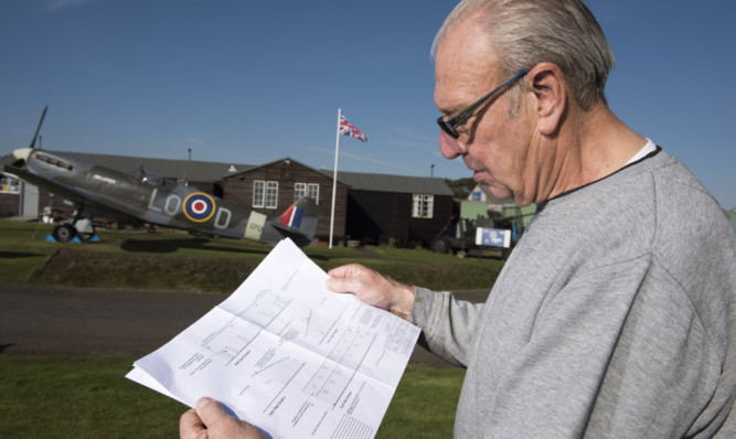 Trustee Brian Crozier looks over the plans drawn up by Kerry Smith Architects for the planned new building at the heritage centre.