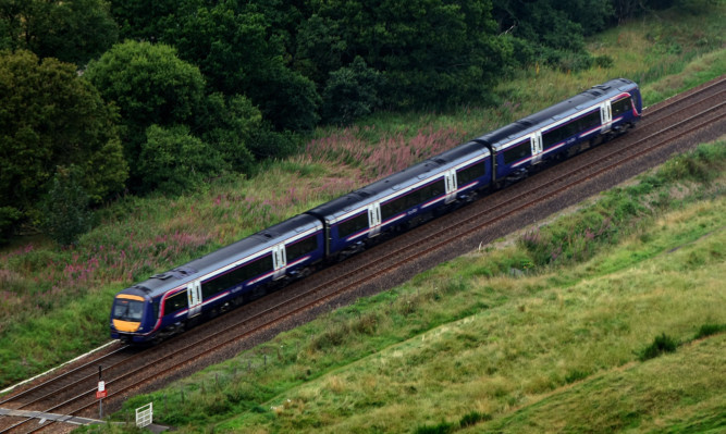 Kris Miller, Courier, 08/09/15. Picture today shows a Scotrail train on the tracks near Blackford.