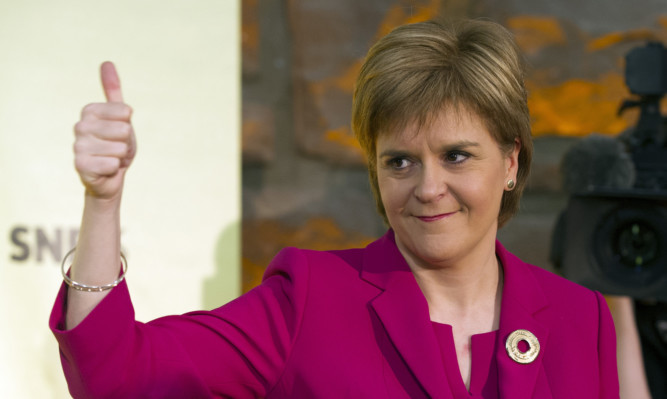 First Minister Nicola Sturgeon gives a thumbs up after giving a keynote speech one year on from Scotland's independence referendum at South Hall Complex in Edinburgh. PRESS ASSOCIATION Photo. Picture date: Friday September 18, 2015. The SNP leader insisted that ruling out another vote on independence indefinitely would be "wrong". See PA story POLITICS Referendum. Photo credit should read: Lesley Martin/PA Wire