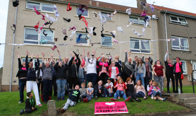 Talk of the town: residents under the chain with some of the donated bras.