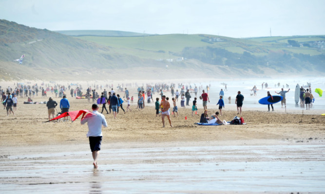 Beachgoers at Woolacombe in Devon on Sunday.