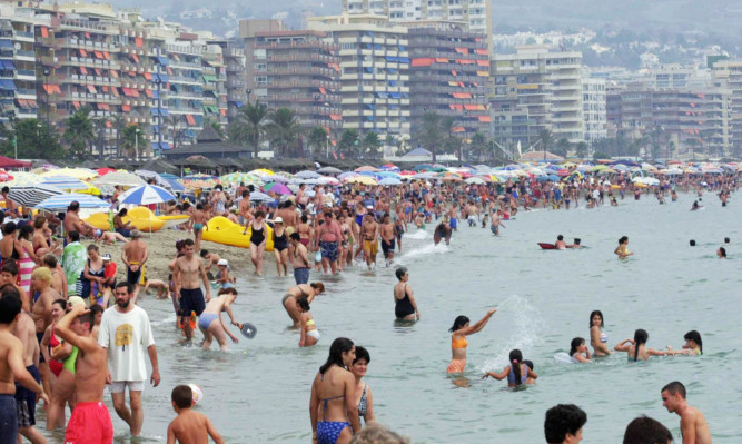 File photo dated 29/07/01 of people on the beach at Fuengirola on the Costa Del Sol in Spain, as using the internet on your mobile while abroad can end up costing more than the holiday itself, Citizens Advice is warning. PRESS ASSOCIATION Photo. Issue date: Friday August 14, 2015. See PA story CONSUMER Roaming. Photo credit should read: Stefan Rousseau/PA Wire
