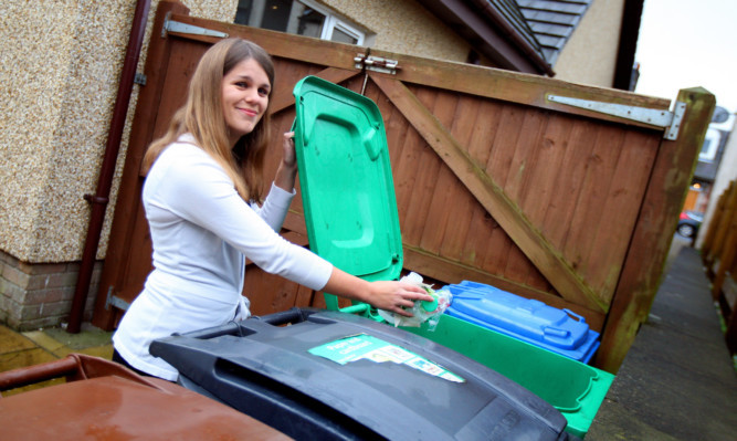 Karen Stewart-Russell, from Markinch,  putting plastics in one of her wheelie bins.