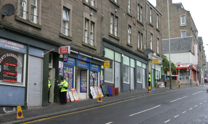 Police outside the entrance to the flat where Shaun McBeath was killed.