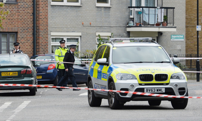 Police at the scene near to the junction of Scriven Street and Haggerston Road in Hackney east London, after a policeman was shot and wounded during an armed operation.