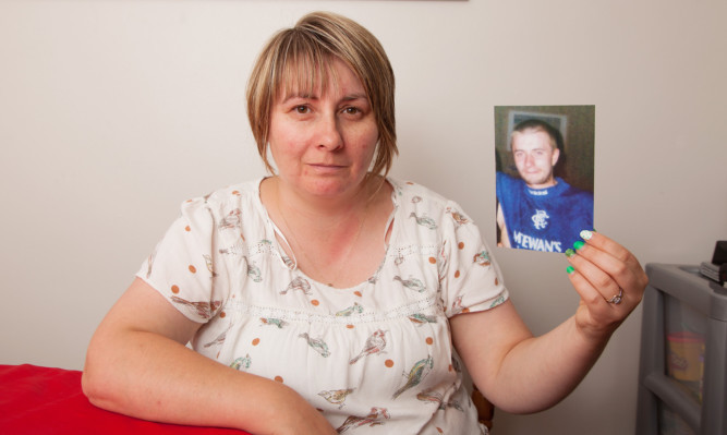 Laura McKay with a photo of her brother Michael who died after using 'legal highs.'