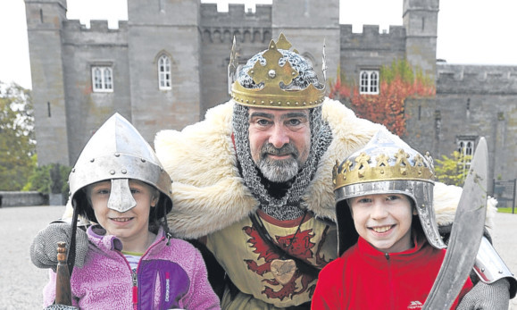 Katie and Angus Badenoch are pictured at Scone Palace with King Robert the Bruce, otherwise known as Brian McCutcheon.