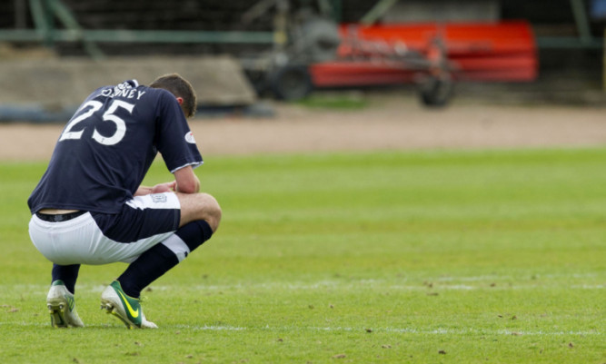 Dundee's penalty villain Lewis Toshney can't hide his disappointment.
