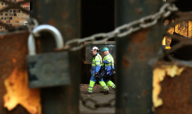 Steel workers at the Tata Steel plant in Motherwell after the company confirmed that it is to close its two plants in Scotland with the loss of 270 jobs.