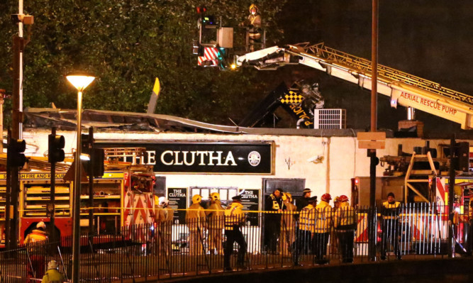 Police and Scottish Fire and Rescue services at the scene ofthe helicopter crash at the Clutha Bar in Glasgow.