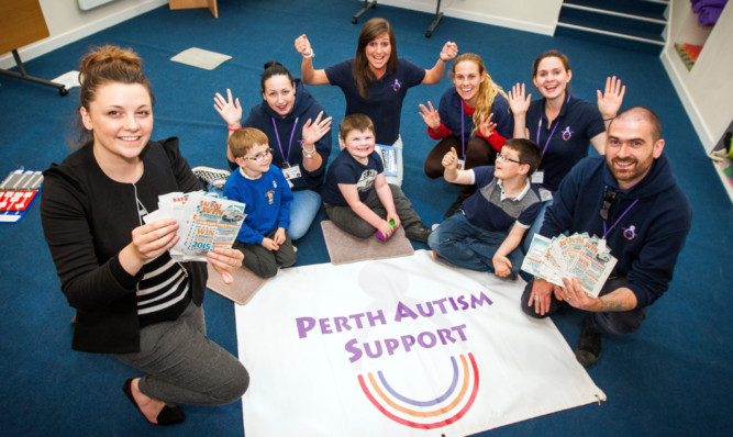 Kathleen MacLeod and Ross MacGregor with activity assistants and some of the children that attend the group.