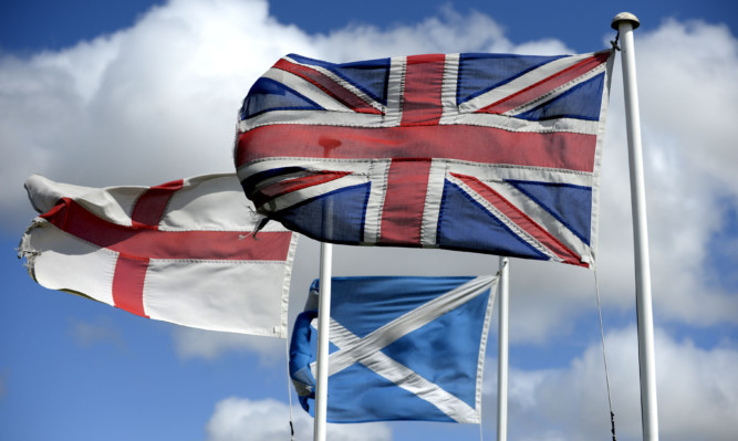 The Flags of  St George, the flag of Scotland and the Great Britain flag fly high in North Northumberland not far from the Scotish Boarders.In 6 weeks the vote for Scotish Independance will take place .....PA Photo Owen Humphreys