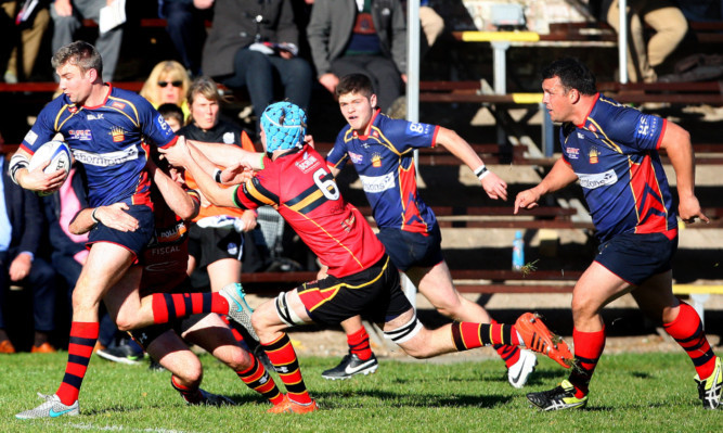 Danny Levison leads the charge for Dundee High with Ronan Joy and Alan Brown in support.