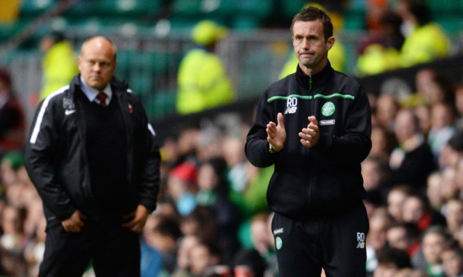 United boss Mixu Paatelainen (left) looks on as Ronny Deila applauds his Celtic players.
