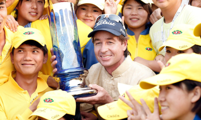 Brett Rumford celebrates his second successive European Tour victory at the Volvo China Open in Tianjin.