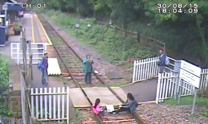 Network Rail have released picutres of children sitting on the rails while having their photo taken at Matlock Bath station in Derbyshire.