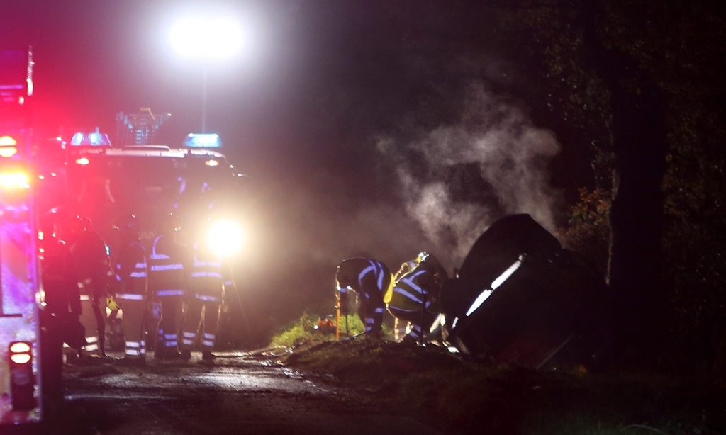 Kris Miller, Courier, 26/10/15. RTC near Guildtown, Perth. A serious two vehicle collision which then saw both vehicles engulfed in flames happened early evening. Pic shows members of the firebrigade beside vehicles with steam/smoke still rising from them **Please make sure no number plates are visible**