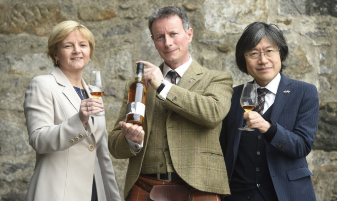Aberdeen Council leader Jenny Laing, Lord Bruce, honorary patron of the Japan Society of Scotland, and Mr Hajime Kitaoka, Consul General of Japan, make a toast at Aberdeen Maritime Museum. Picture: Greg Macvean.