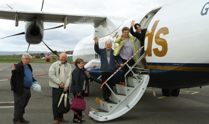 Some of the holidaymakers boarding the 21st anniversary Blue Islands flight to Jersey on Saturday.