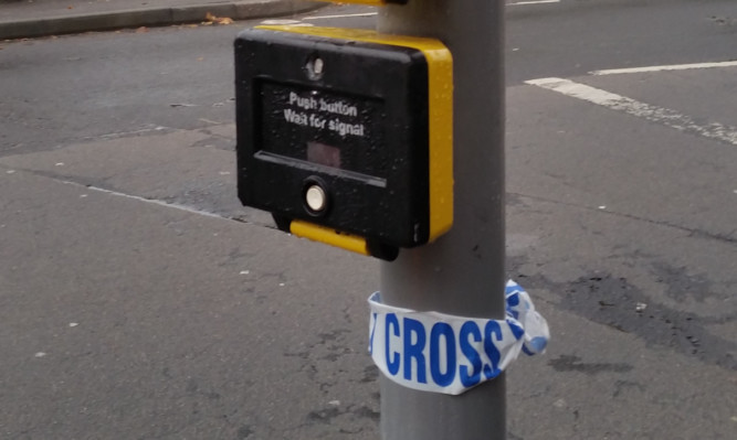 The remains of police tape at the crossing.