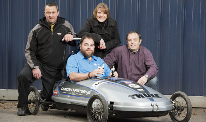 Gavin Brymer and Fiona and Paul Knowles with Campbell Archibald in the cartie from Alba Power, the main race sponsor.