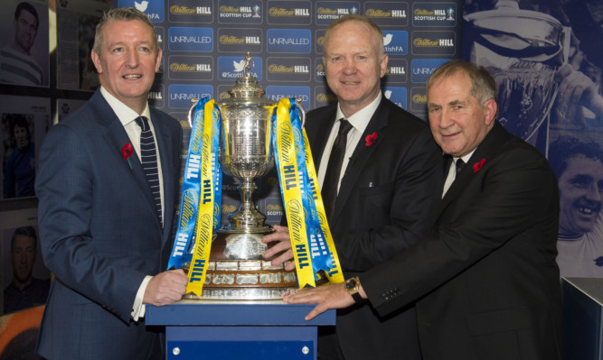 From left: William Hill's Eddie Thomson, former Scotland national coach Alex McLeish and Scottish FA President Alan McRae with the trophy.