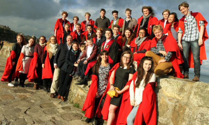 Rector of St Andrews University Catherine Stihler with her husband David and sons Andrew  and Alex and some of the St Andrews University students on their traditional 'pier walk'