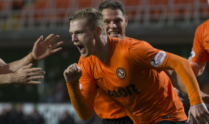 Billy Mckay celebrates scoring the winning penalty.