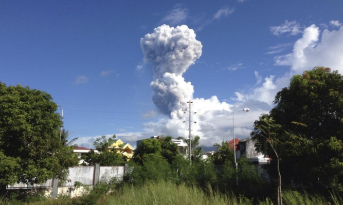 A cloud of volcanic ash shoots up from the Mayon volcano.