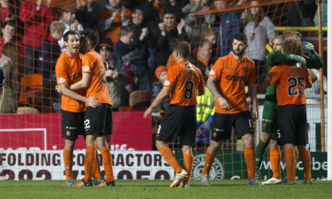 United's players celebrate at the fiinal whistle.