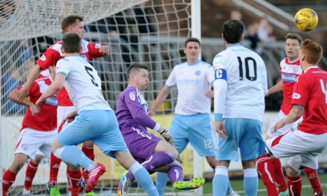 City goalkeeper Graeme Smith punches the ball clear during a Forfar attack.