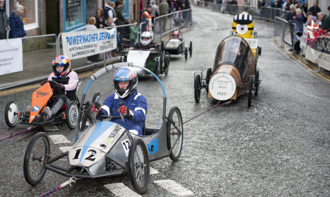 Cartie drivers are hauled uphill to the start line.