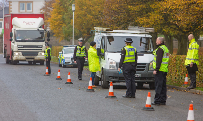 Police check vehicles at Randolph Industrial Estate in Kirkcaldy.