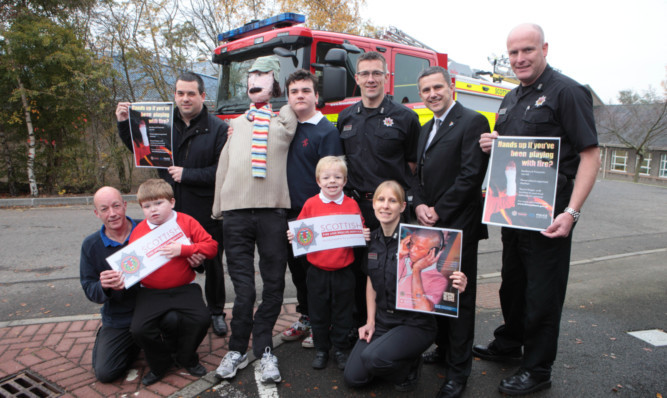 Raising awareness of Bonfire Night safety: Gavin Finn of Fairview School with Kevin Poynter, Craig Taylor of Perth Strathearn Round Table, pupils Callum Crosbie and George Smith, firefighters Stephen Wood and Sarah Robertson, and Paul Sharkey of Perth Strathearn.