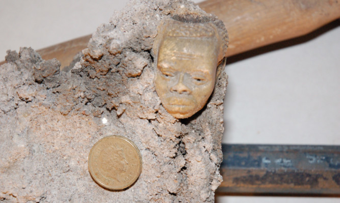 The mysterious pipe head, shown alongside a pound coin for scale.