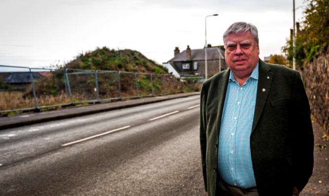 Councillor Kay at the site which is at the centre of development concerns.