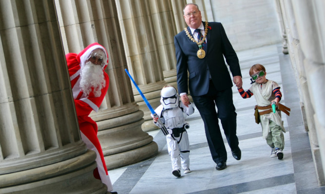 Santa keeping an eye on proceedings as Lord Provost Bob Duncan is escorted by Storm Trooper Oscar and Bounty Hunter Freddy.