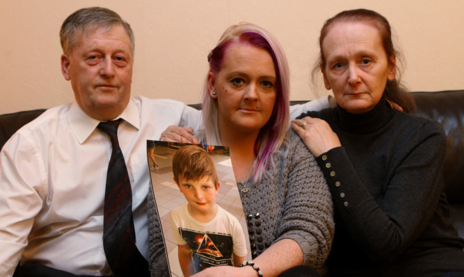 Kairon's mother Laura Mckay with a picture of her son Kairon, and her parents Hector and Moira Mckay.