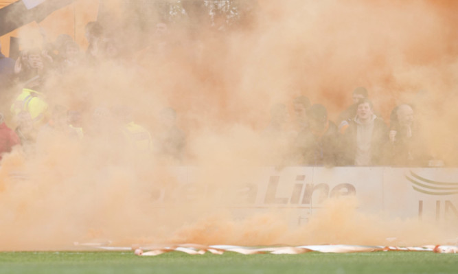 Smoke from the flare thrown on to the pitch at Stranraer.