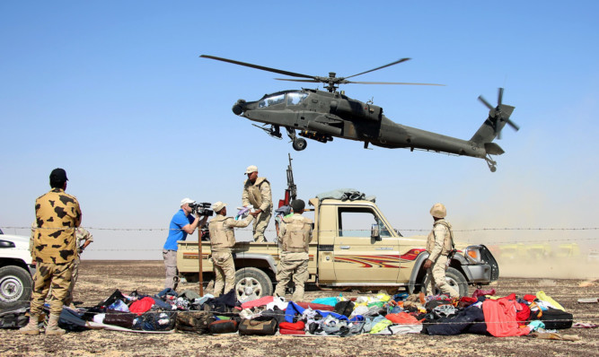 Egyptian officials inspect the crash site of Russian Airliner.