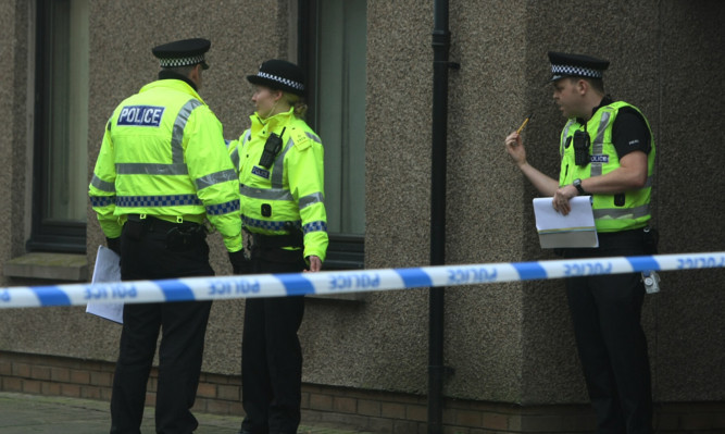 Police outside a property in Montrose on Thursday.