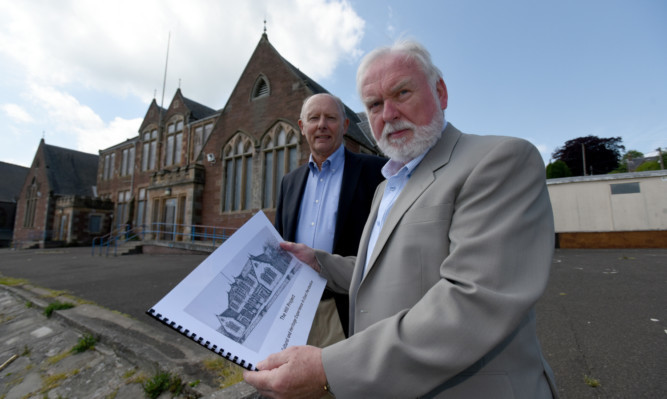 Mike Stevenson, left, a trustee of the Ericht Trust, and Ian Gordon, trust chairman, with a document outlining the groups proposal to buy the listed building.