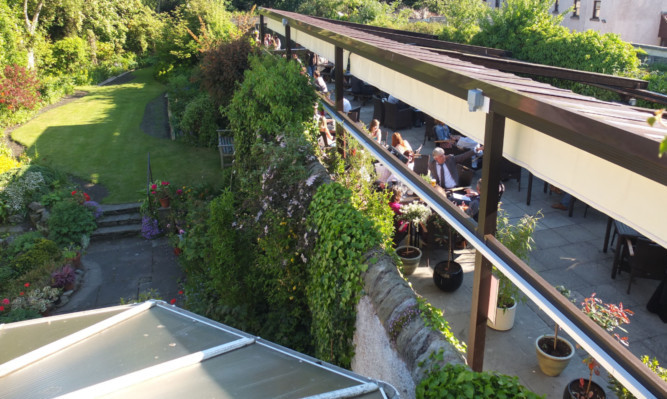 The West Port Bar and Kitchen covered beer garden runs alongside a residential property.