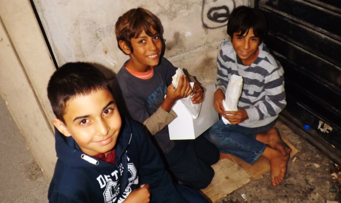 Shahbazz Afzal, 12, handing out food parcels to Syrian refugee children in Istanbul.