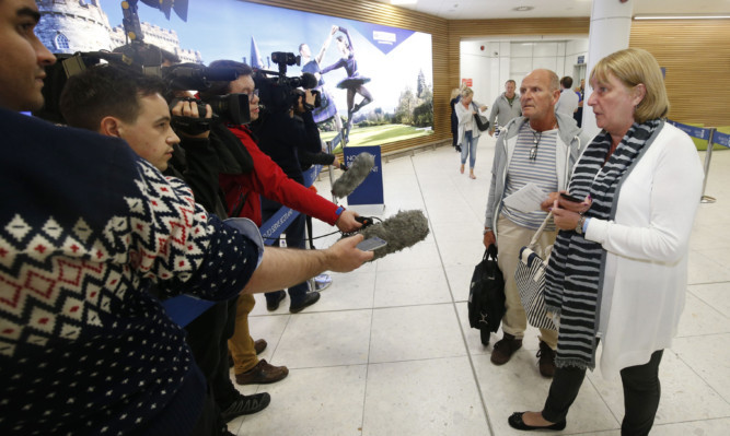 Brian and Grace Shaw talk to the media as they arrive back at Glasgow Airport.