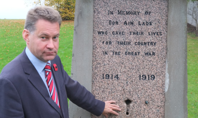 MSP Murdo Fraser beside the memorial fountain in the Jeanfield area of Perth.