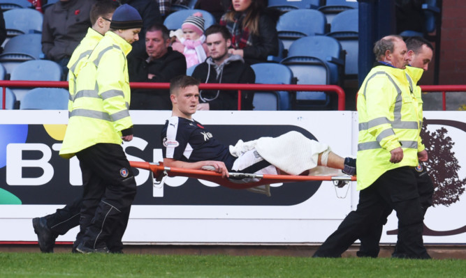 Rhys Healey is carried off injured.