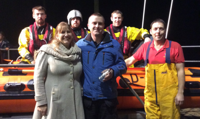 Newly-engaged Nicky Titchener and Grant Norrie with members of Anstruther lifeboat crew.
